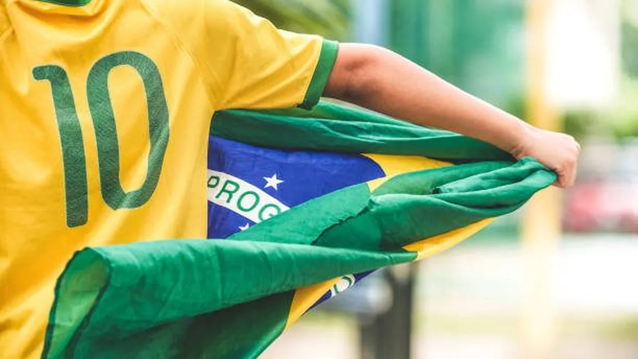 Torcedores assistindo jogo do Brasileirão em TV aberta na sala de casa com bandeiras dos times