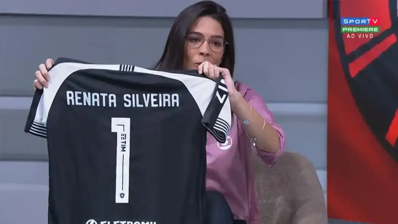 Comentarista esportiva feminina durante transmissão ao vivo em estúdio de televisão com equipamentos profissionais
