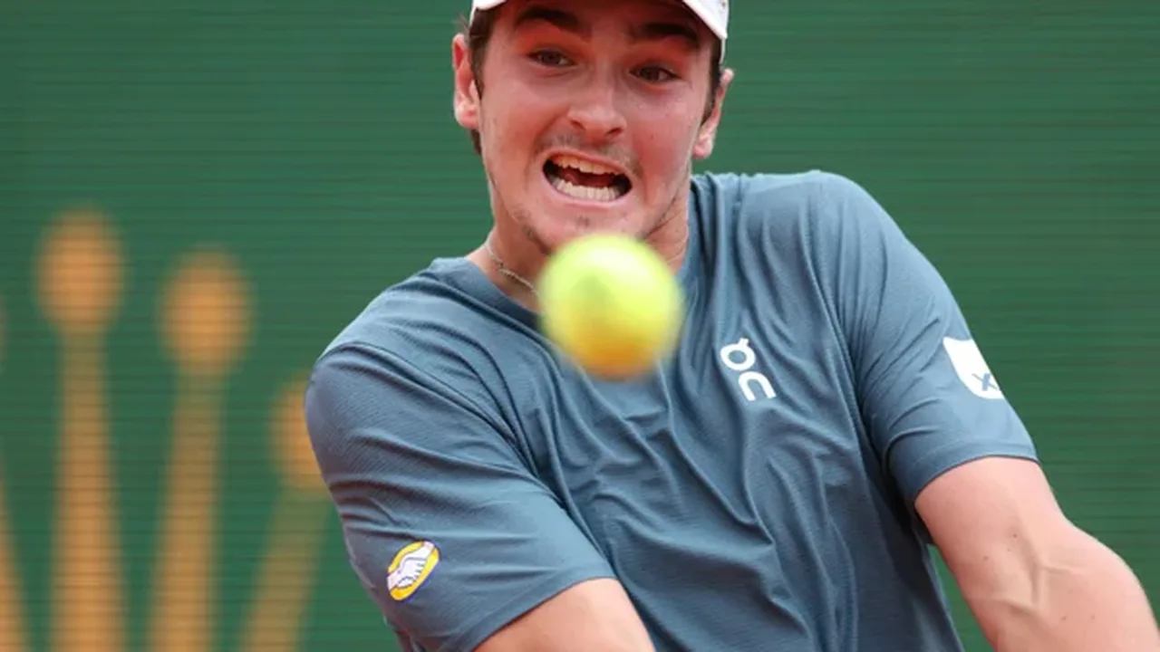 João Fonseca durante partida de tênis em quadra de saibro com raquete em posição de forehand