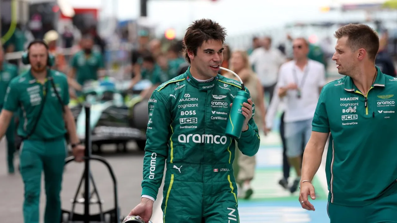 Lance Stroll no cockpit do Aston Martin durante treino da Fórmula 1, com equipe técnica ao fundo no paddock
