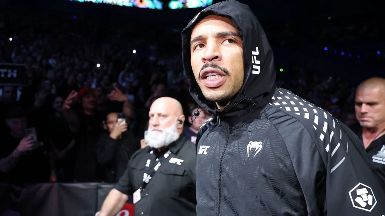 Carlos Prates em posição de guarda no octógono do UFC, com cinturão dos meio-médios ao fundo