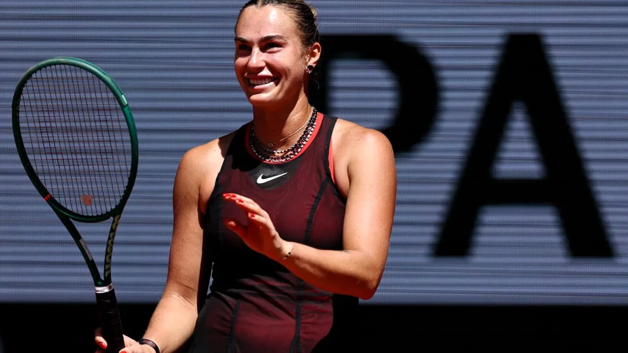 Aryna Sabalenka em quadra de saibro em Roland Garros, com raquete levantada após ponto vencedor