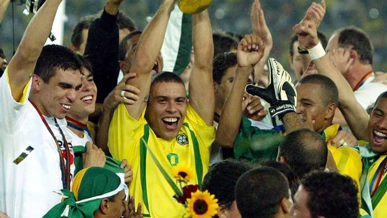 Criança jogando futebol em campo de terra ao pôr do sol, representando a popularidade global do esporte